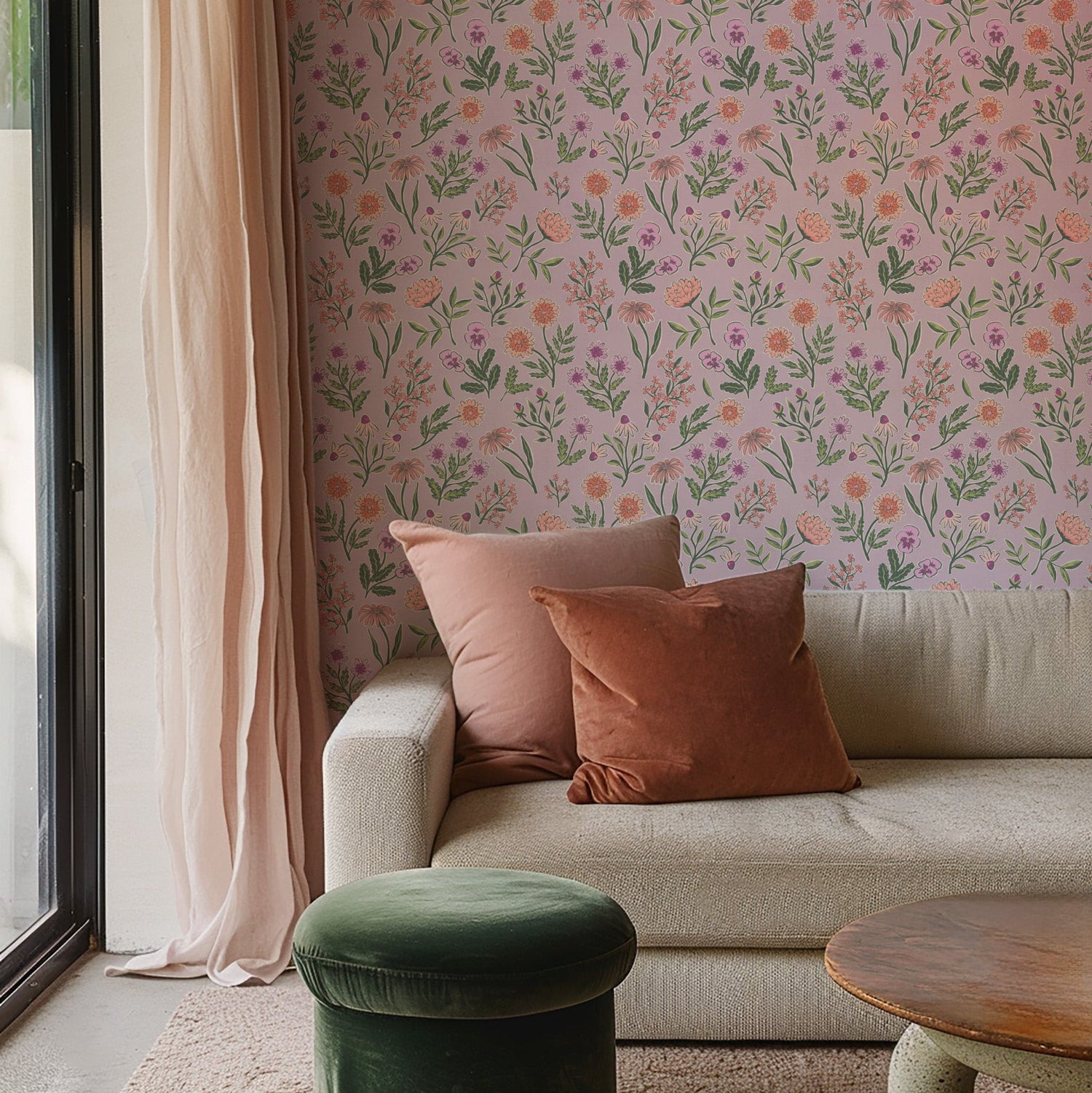 Living room with floral wallpaper, beige sofa, and green ottoman.