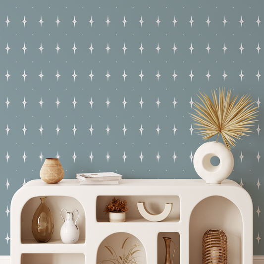 Star patterned wallpaper with a staged shelf