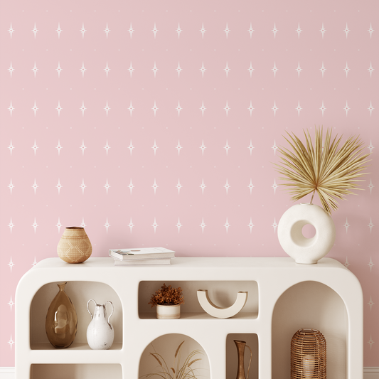 Pink wallpaper with white stars behind a staged shelf