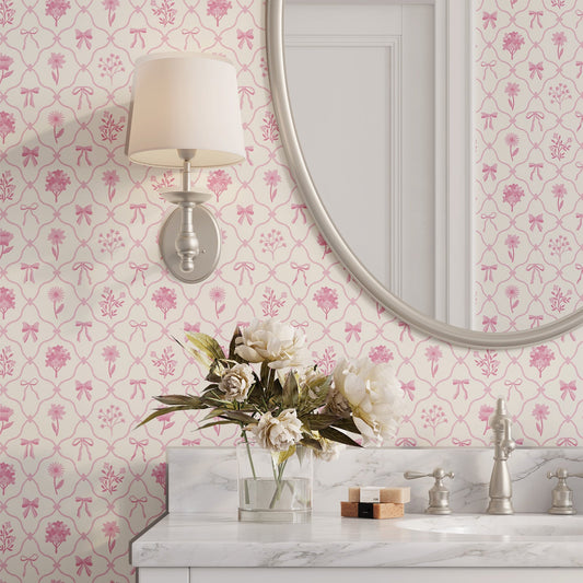 Bathroom with our Something Pink wallpaper with bows and flowers, marble countertop, and decorative elements.