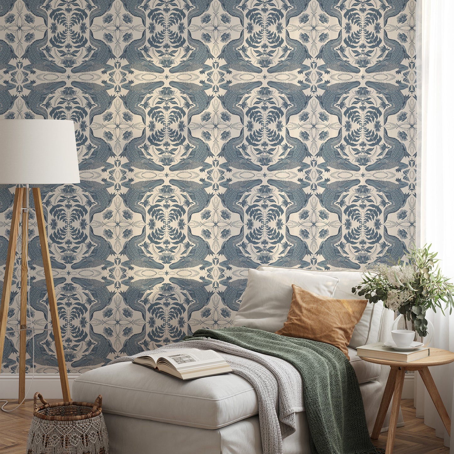 Living room with blue and white patterned wallpaper, beige sofa, and decorative elements.