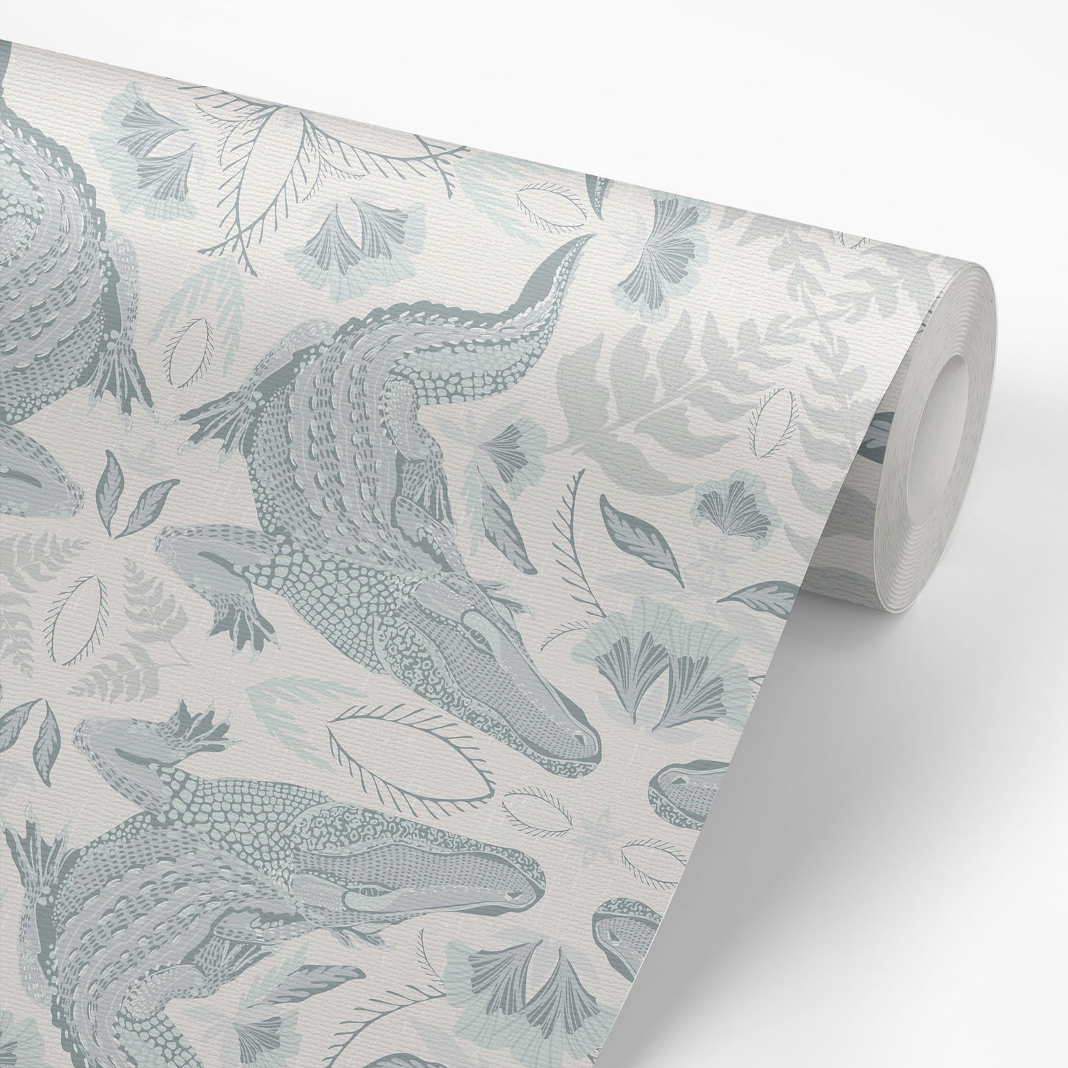 Roll of wallpaper with crocodile and leaf pattern on a light background