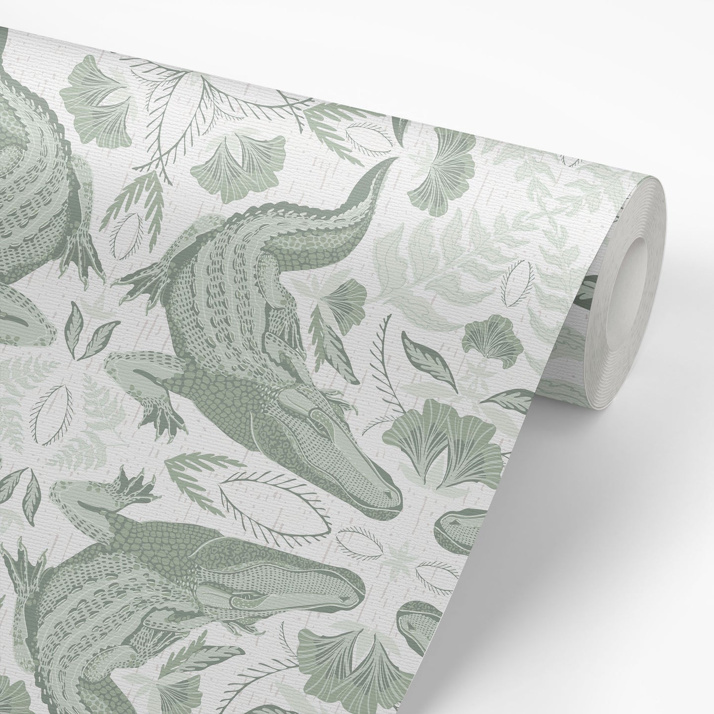 Roll of wallpaper with green crocodile and leaf pattern on a light background