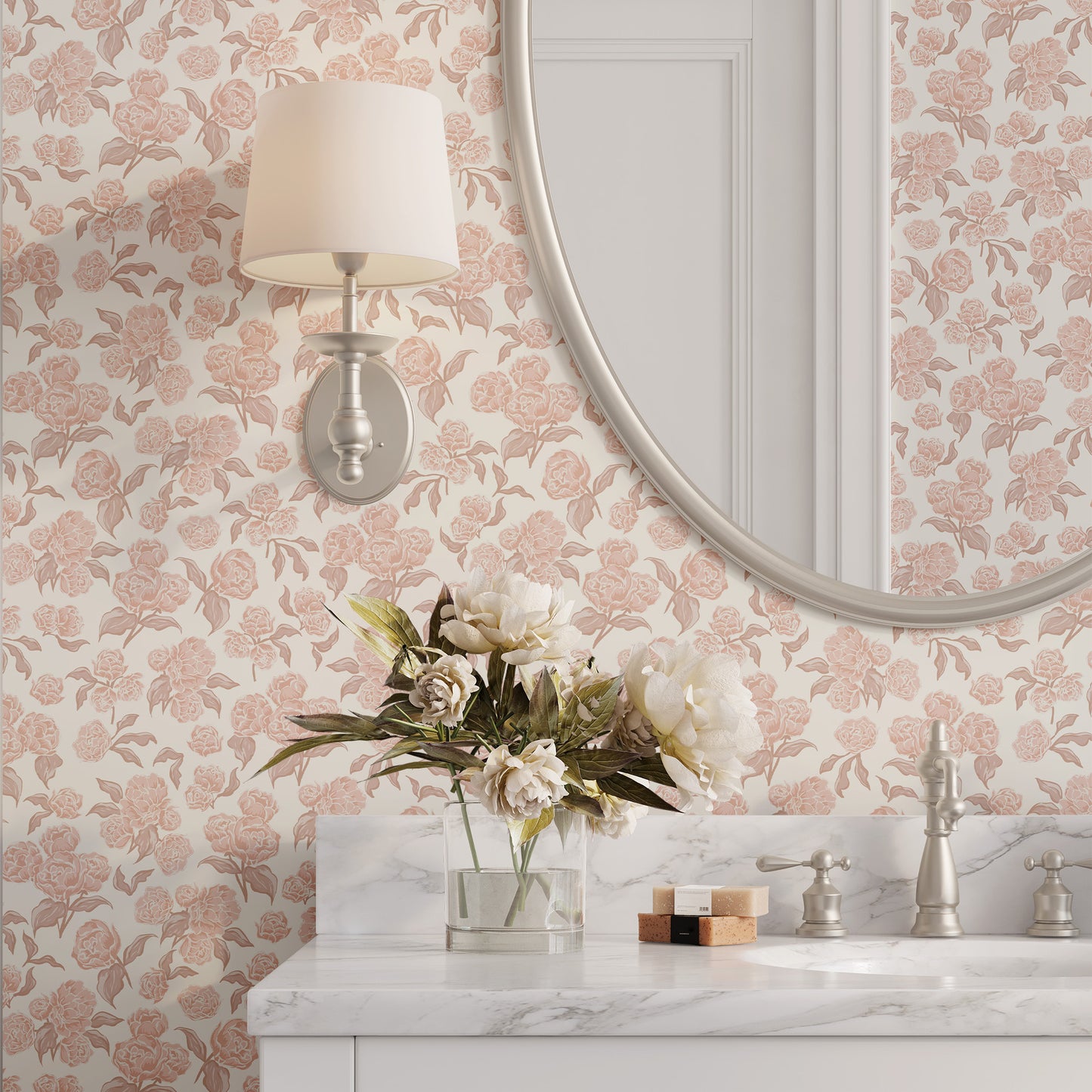 Bathroom with pink floral wallpaper, round mirror, and marble countertop.