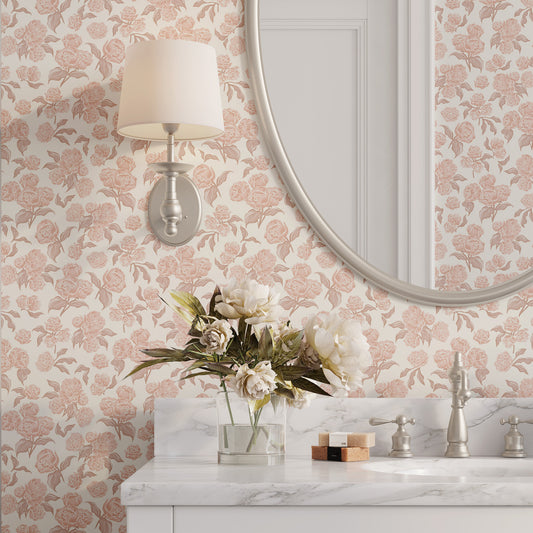 Bathroom with pink floral wallpaper, round mirror, and marble countertop.
