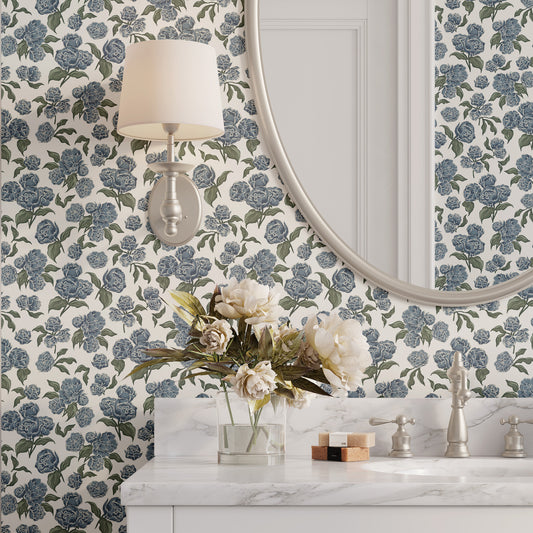 Bathroom with blue floral wallpaper, round mirror, and decorative elements.
