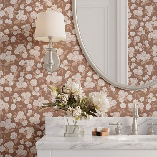 Bathroom with floral wallpaper, round mirror, and marble countertop.