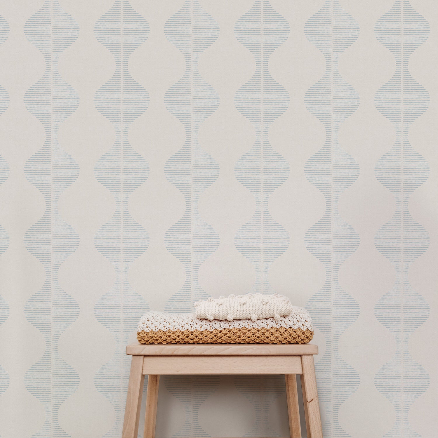 Bring a wave of modern beauty to any room with this stunning Wavy Line Art Wallpaper! The subtle pale blue on cream design is completely gorgeous and sure to make a statement in any space.