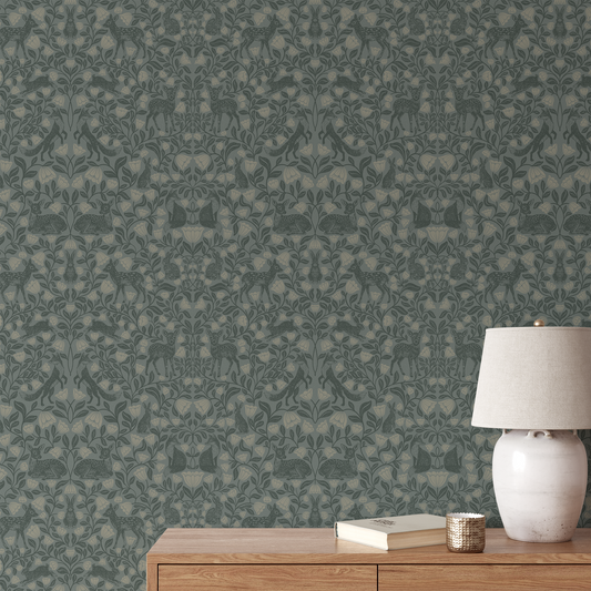 Patterned wallpaper with a wooden side table and lamp in the foreground