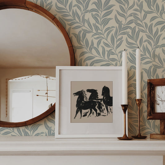 Winding Vines Wallpaper in Cloudy Blue next to a mirror on a mantel