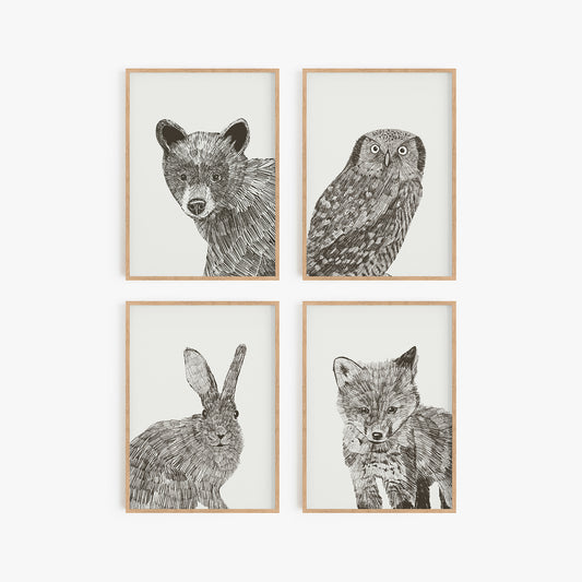 Set of four art prints with woodland creatures: owl, bear, bunny, and fox. Sketched in black and white. Comes in a set of four unframed art prints.