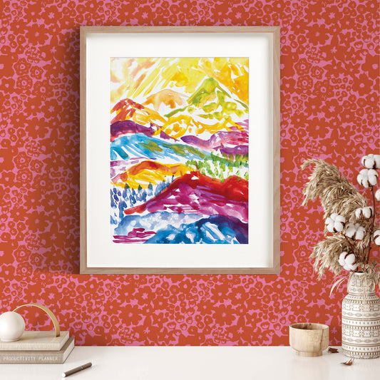 This colorful mountains art print by Iris + Sea is a fun addition to your wall art! Pictured here on a red and pink floral wallpaper designed by the same artist.