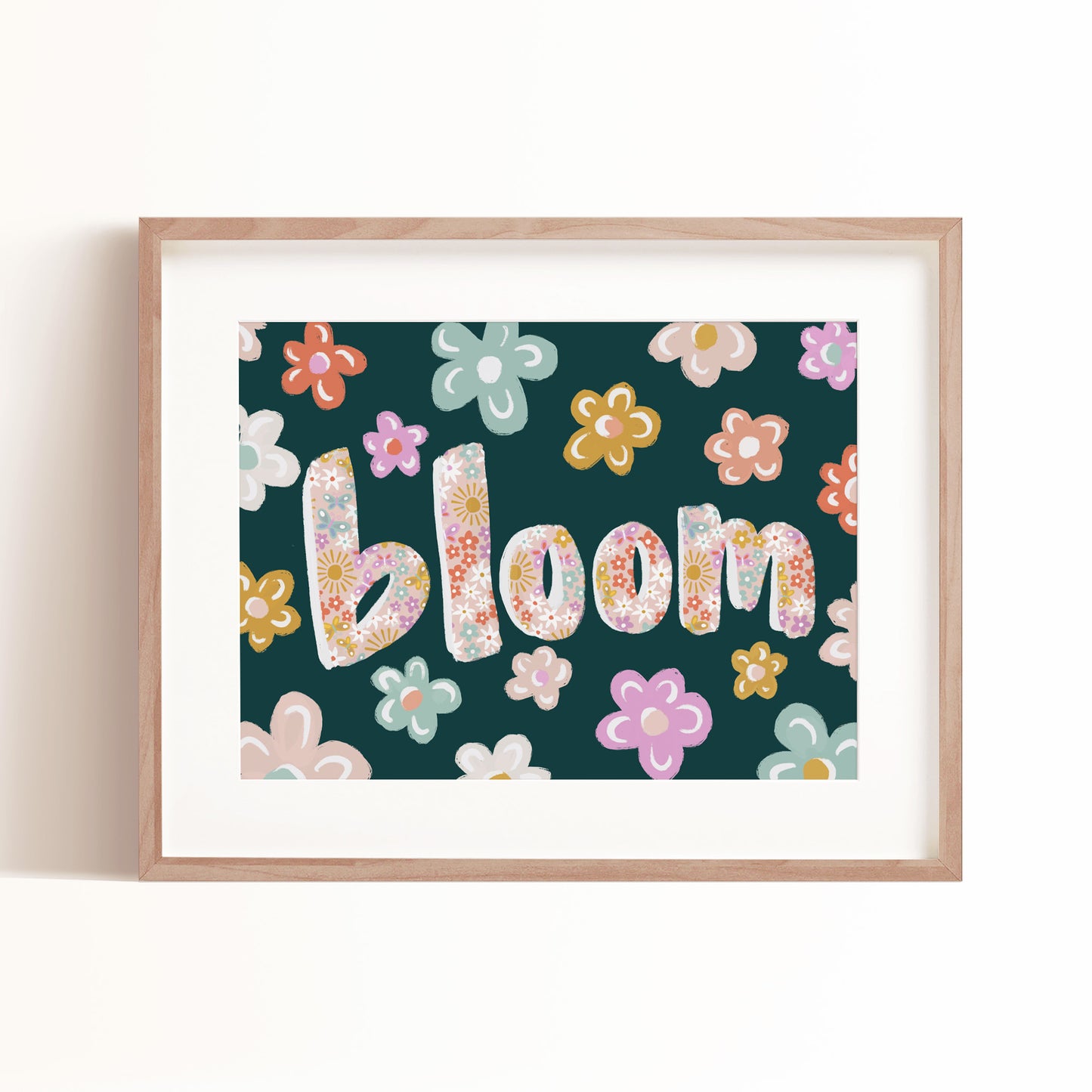 Our Bloom art print pictured in a frame is sure to inspire your loved ones with it's bold and colorful letters.