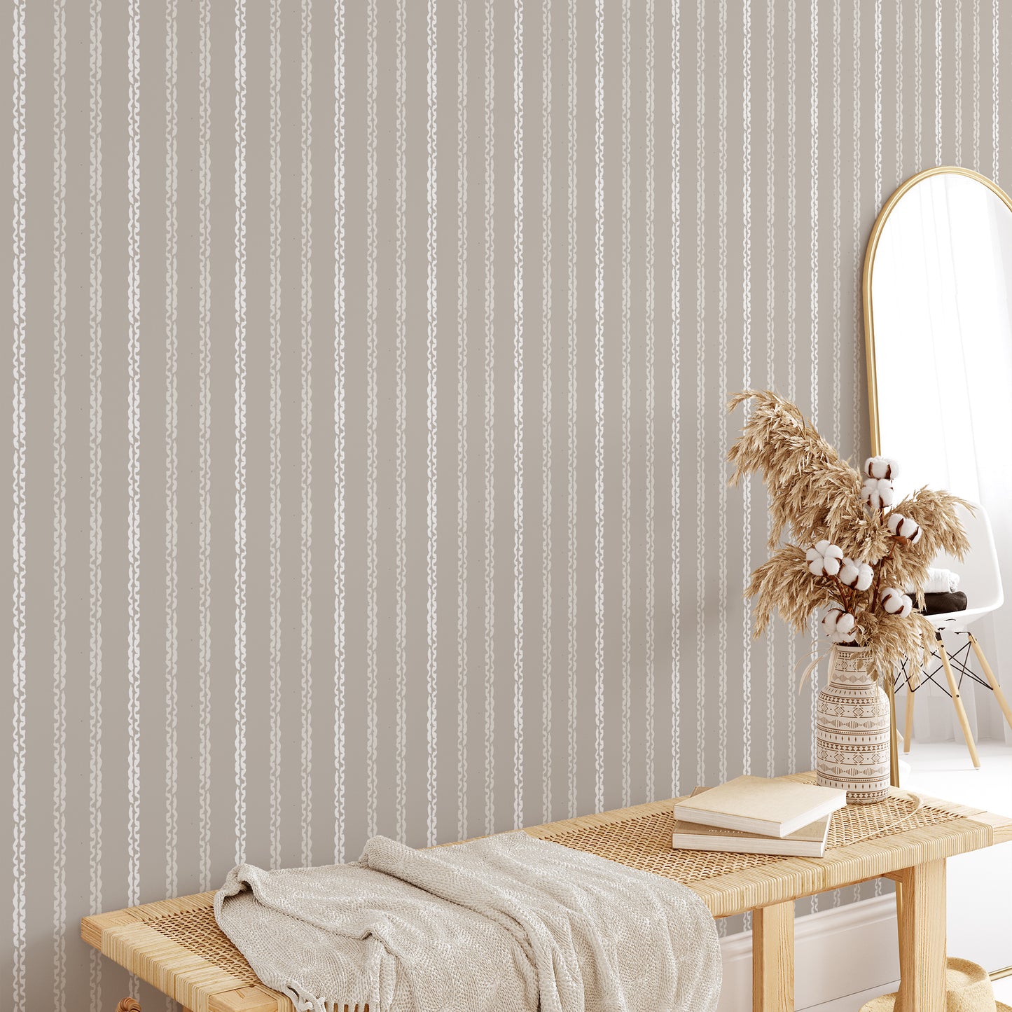 Bedroom wall featuring Clea peel-and-stick wallpaper in clay by Jackie O'Bosky. Taupe and cream vertical stripes.