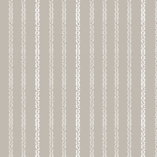Close up featuring Clea peel-and-stick wallpaper in clay by Jackie O'Bosky. Taupe and cream vertical stripes.