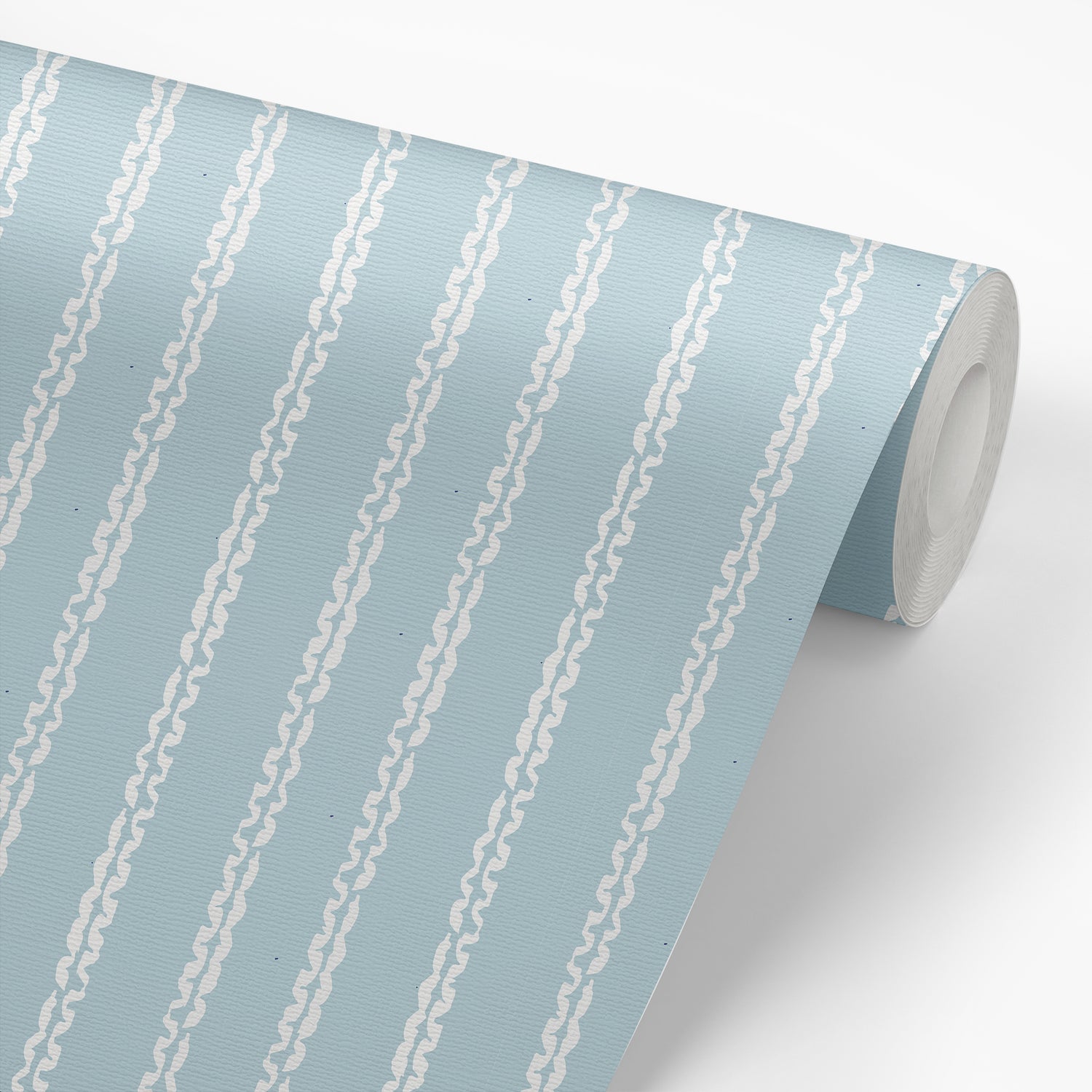 Roll of wallpaper that highlights our  Clea Lake design by our artist Jackie O'Bosky that incorporates stylish vertical lines on a blue background.
