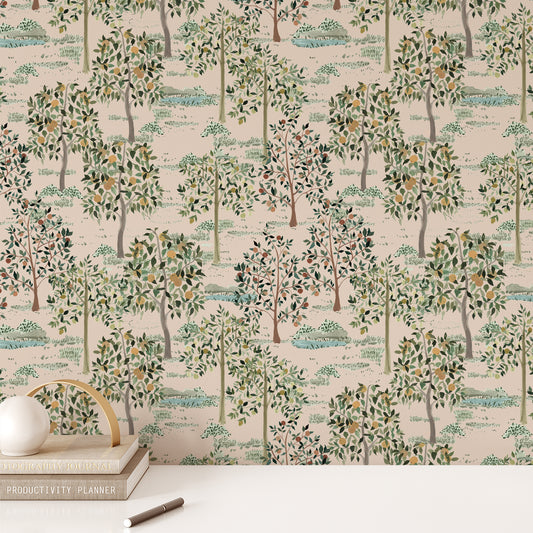 Office wall featuring our Jemma Peel and Stick Wallpaper with a forest of green trees, yellow and orange fruit, and forest ponds. Art by Jackie O'Bosky.