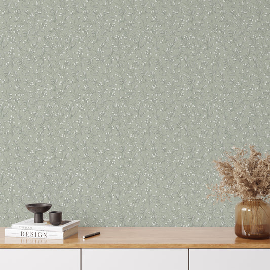This mockup of our Berries Wallpaper in Light Sage shows our peel and stick, removable wallpaper with hand-drawn sketched berries in light sage and white by artist Mariah Cottrell.