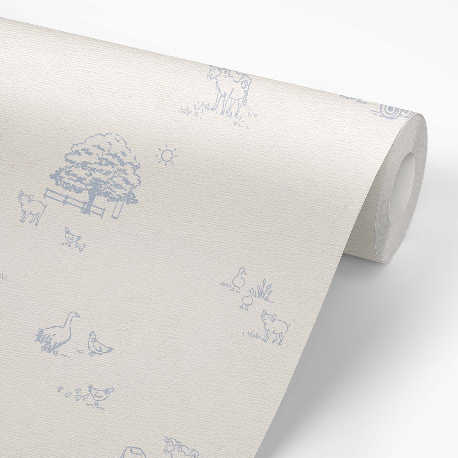 This wallpaper roll shows our Country Farm Wallpaper in Blue. This peel and stick, removable wallpaper was designed by artist Mariah Cottrell and features farm animals and trees in a countryside scene.
