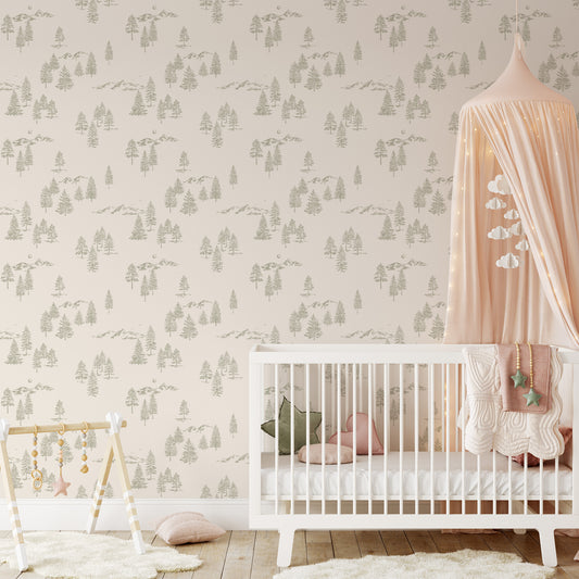 This nursery shows our Mountain Green Wallpaper in Cream. This peel and stick, removable wallpaper was designed by artist Mariah Cottrell and features beautifully sketched mountains and trees.