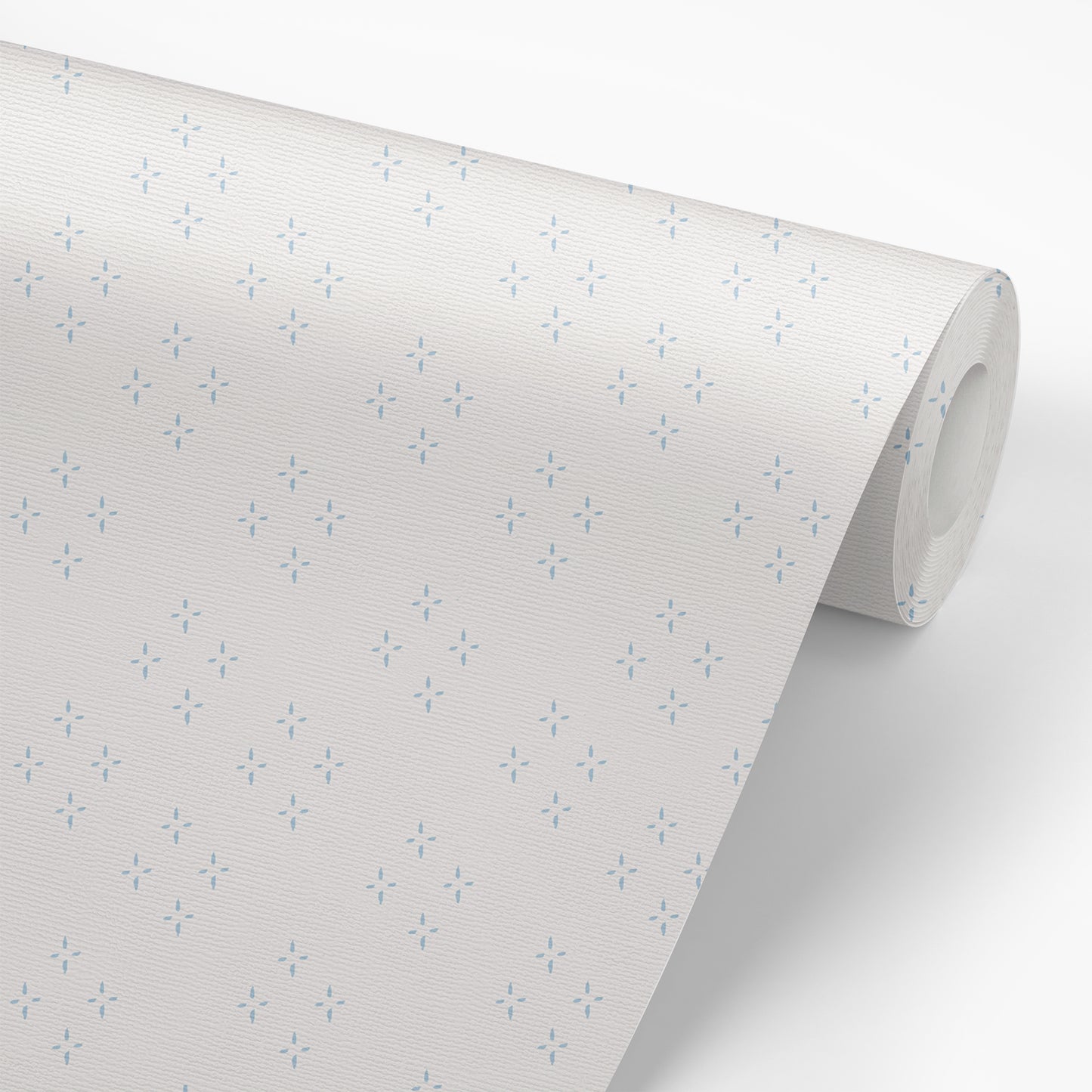 Wallpaper panel featuring our diamond and star shaped Isla peel and stick wallpaper by Jackie O'Bosky. This classic pattern is made of blue dots on a creamy white background.