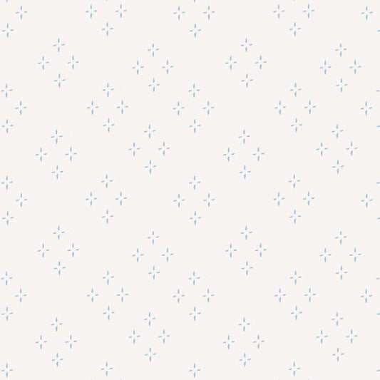 Close up featuring our diamond and star shaped Isla peel and stick wallpaper by Jackie O'Bosky. This classic pattern is made of blue dots on a creamy white background.